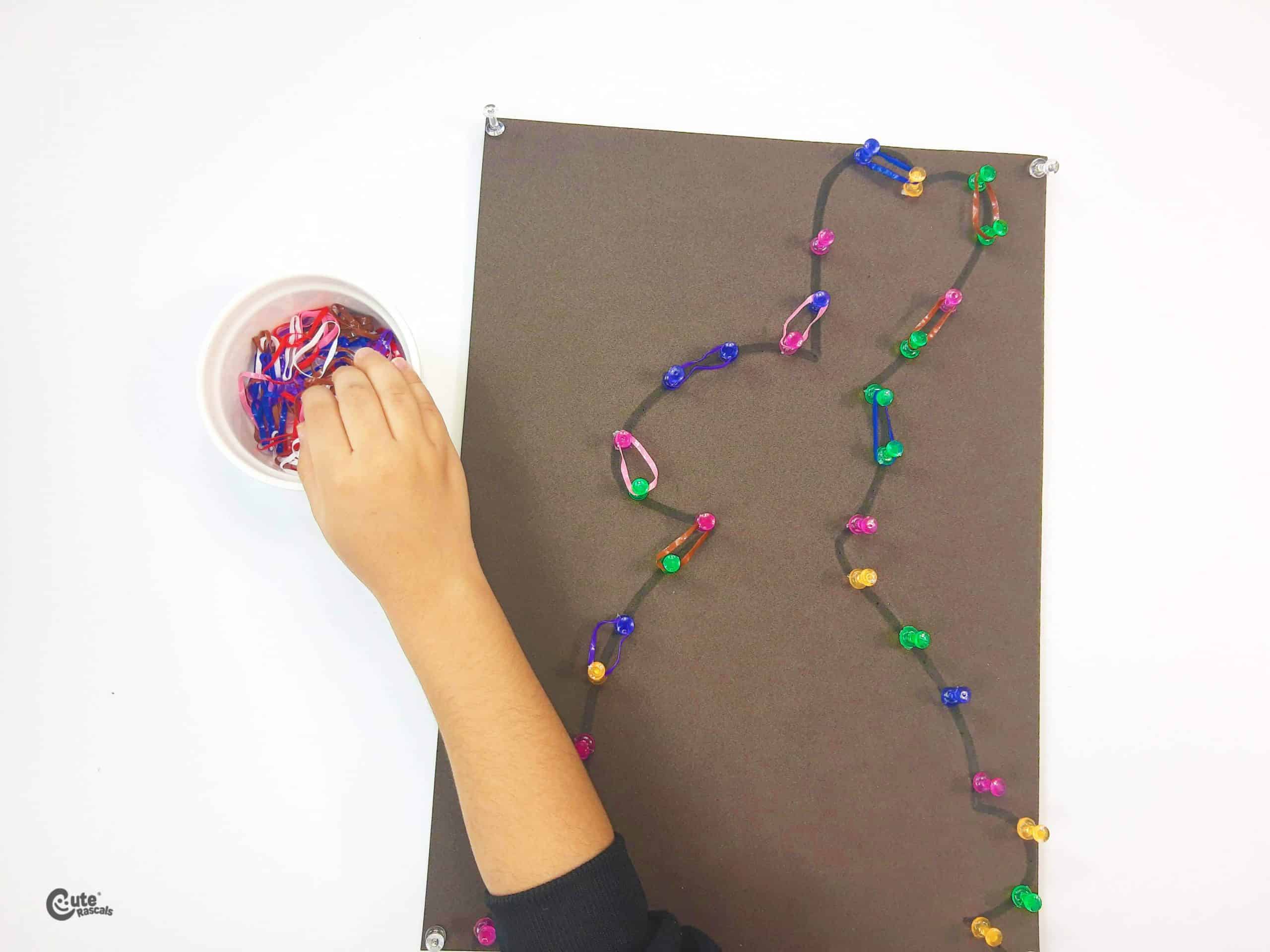 Arrange the colored rubber bands over the thumbtacks. Fun Easter activity